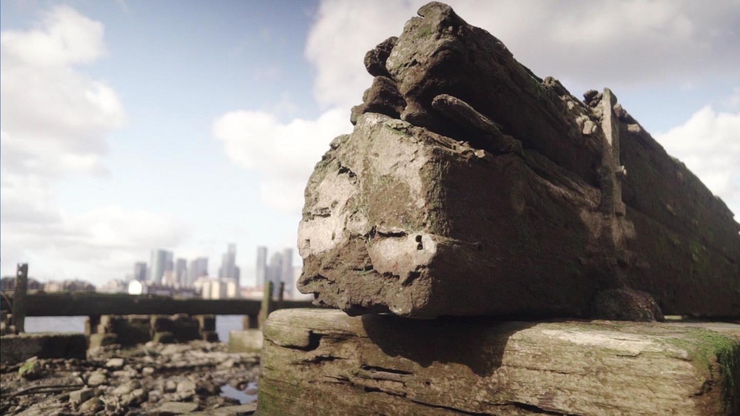 Image of timbers on the Enderby Wharf foreshore with Canary Wharf in the background